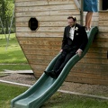 The groom goes down the slide